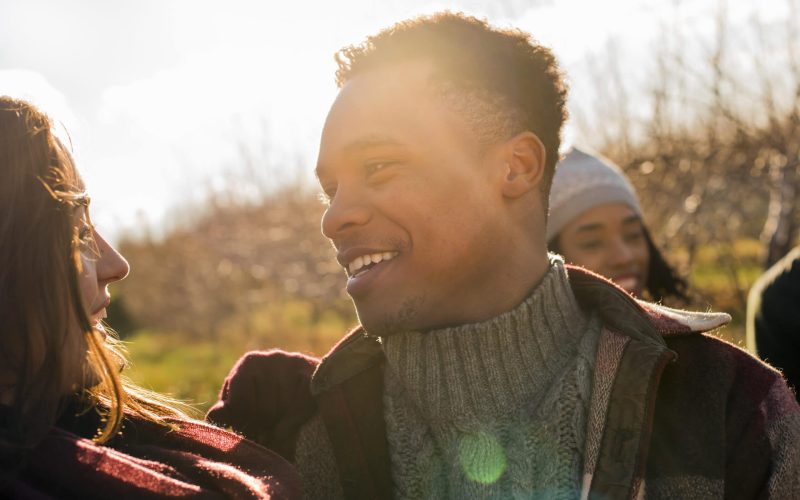 A group of three friends outdoors on a winter walk.